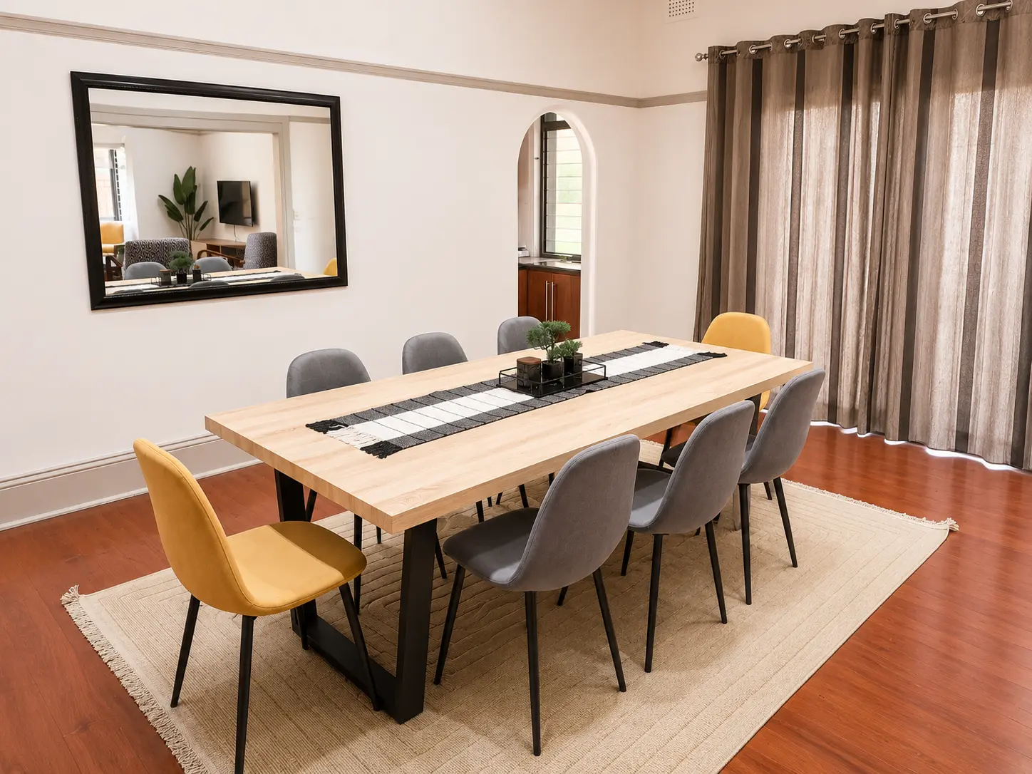 Dining table beside floor length curtains